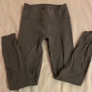 Gray lululemon leggings with floral cutouts/netting.
